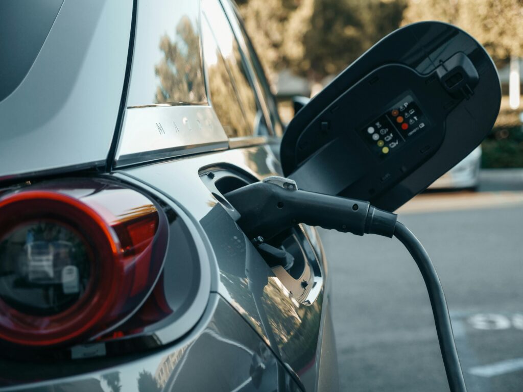 pexels-photo-9800009-9800009 Close-up of an electric vehicle being charged, highlighting modern clean energy technology.